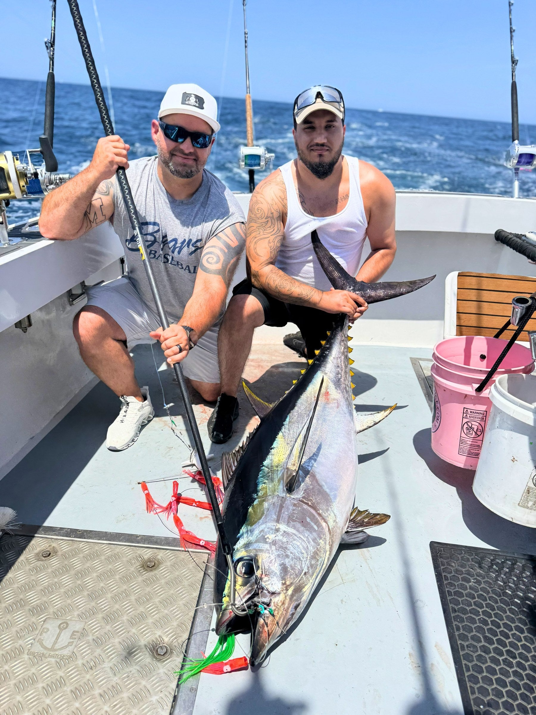 Two anglers with a yellowfin tuna and an E-Fish-Ent carbon fiber gaff