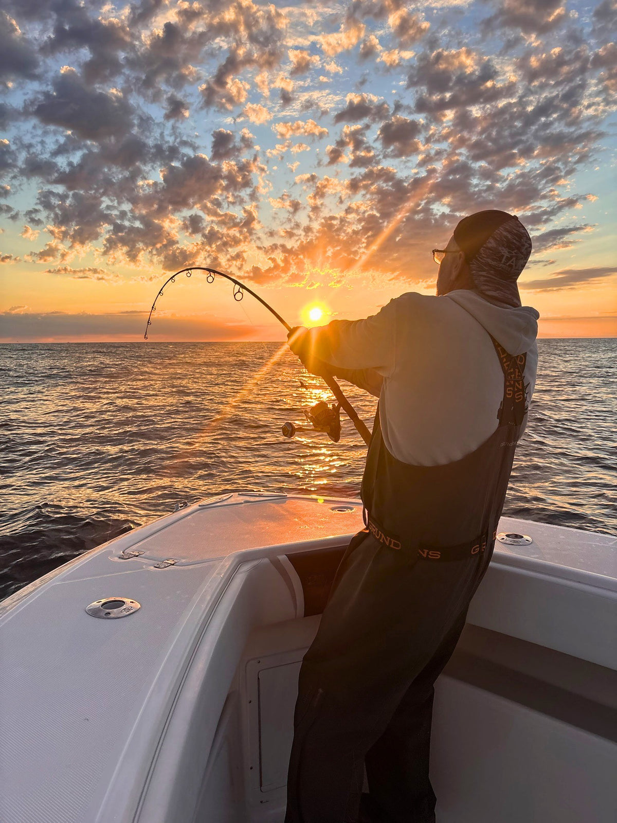Fighting a fish on a Pelagic Sniper rod at sunset