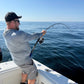 Phantom Jigger rod bent on a fish, angler at the rail