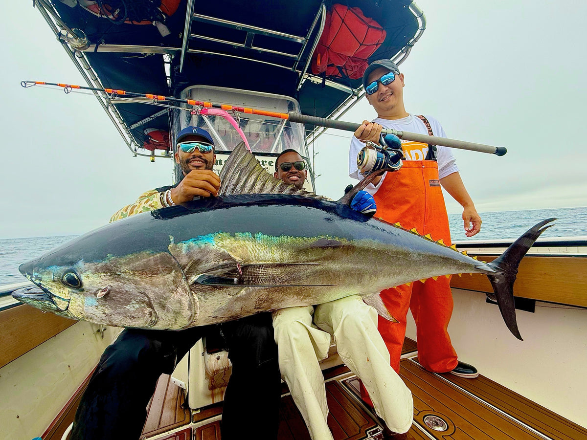 Crew with a bluefin tuna on deck caught on a Vert Giant jigging rod