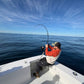 Angler on the bow with a Vert Giant topwater rod loaded up