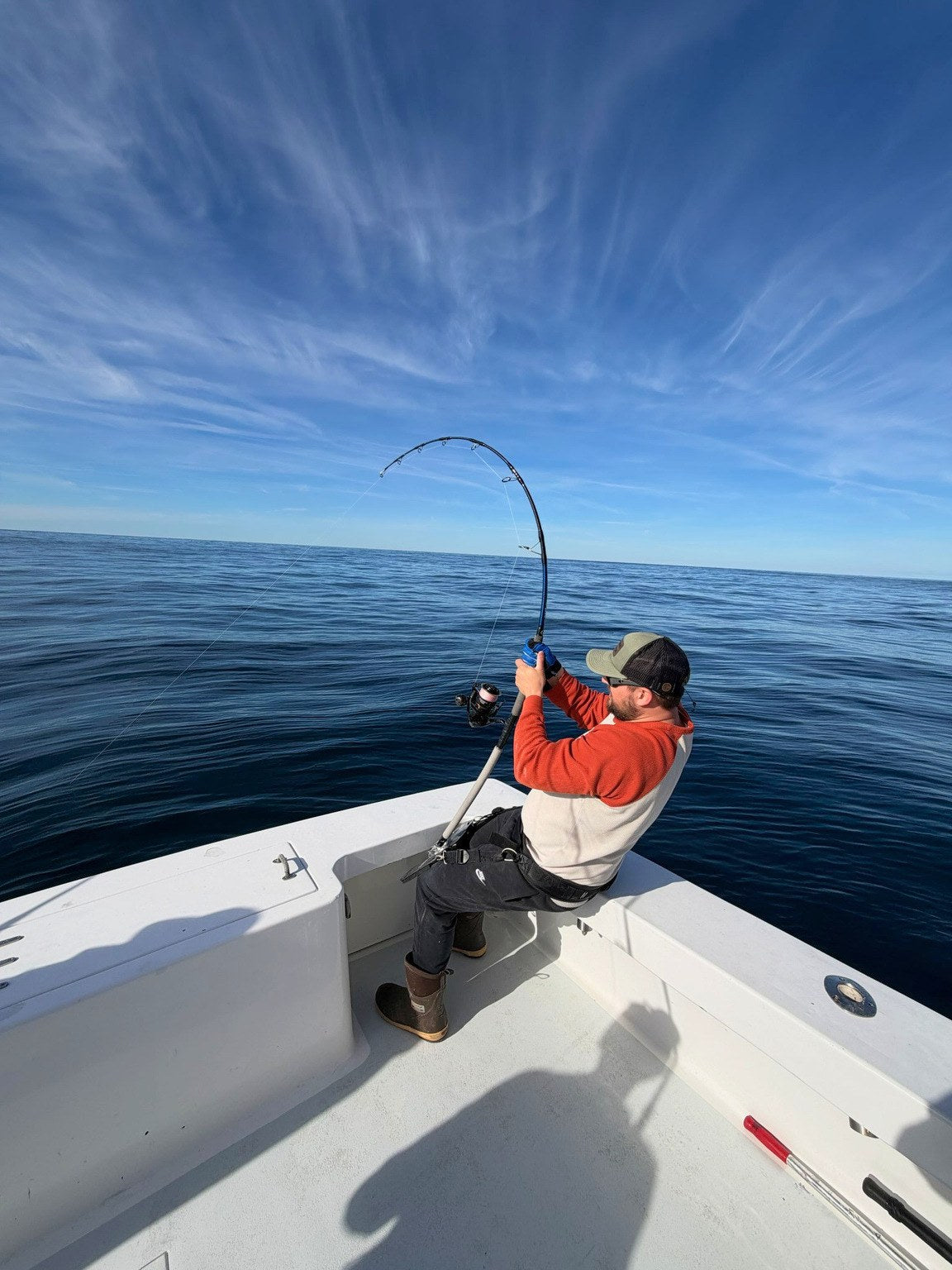 Angler on the bow with a Vert Giant topwater rod loaded up