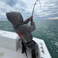 Angler in a hoodie leaning into a Vert Giant topwater rod